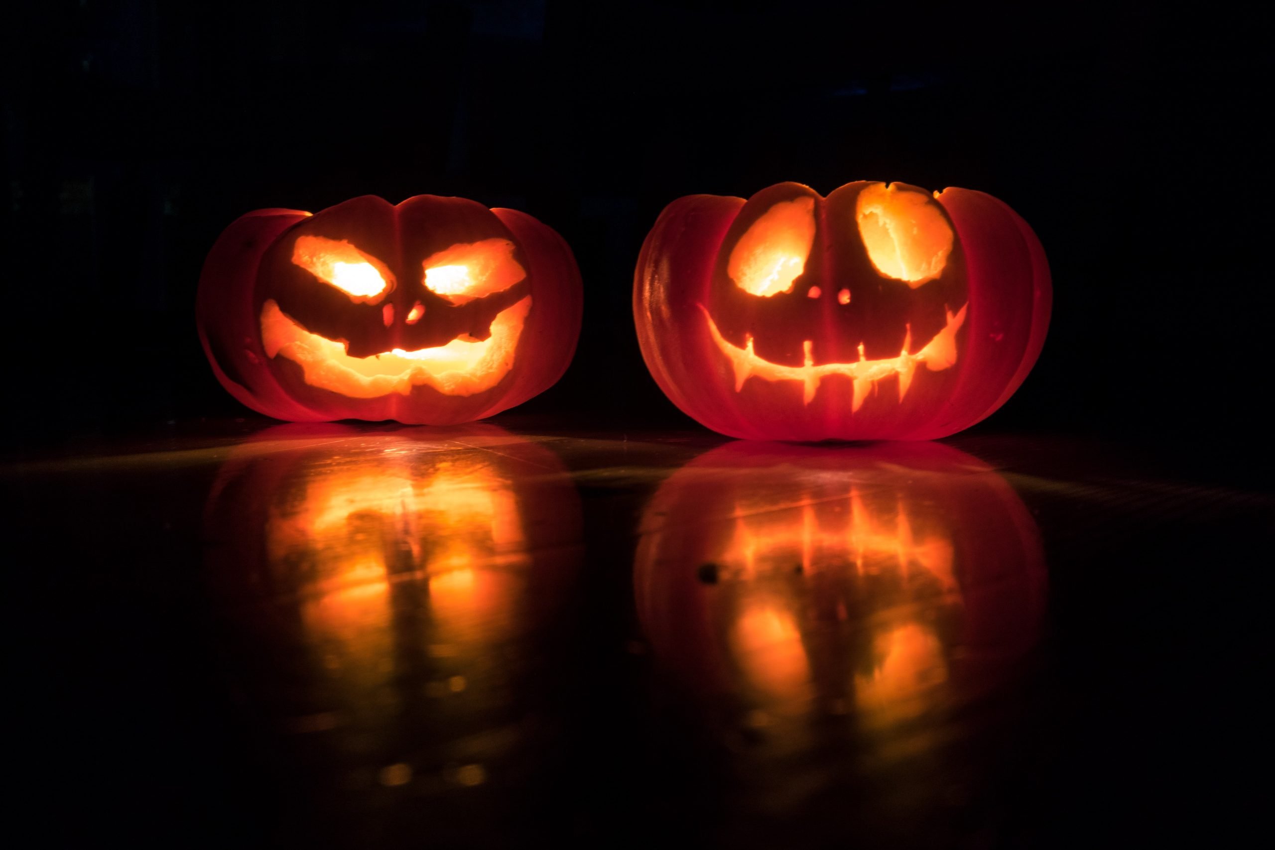 Halloween pumpkins on black background, glowing from within

