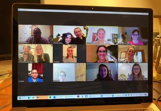 woman sitting on the floor with her back against the wall, about to deliver adrenaline using an adrenaline pen
